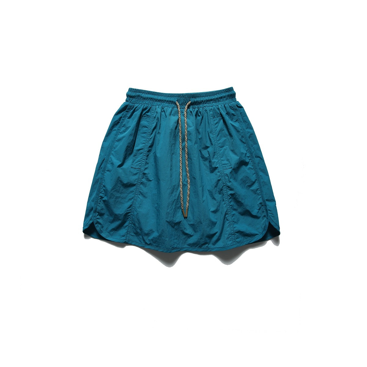 Front view of a teal skirt with an elastic waistband, long drawstring, angled pockets and a curved hem.