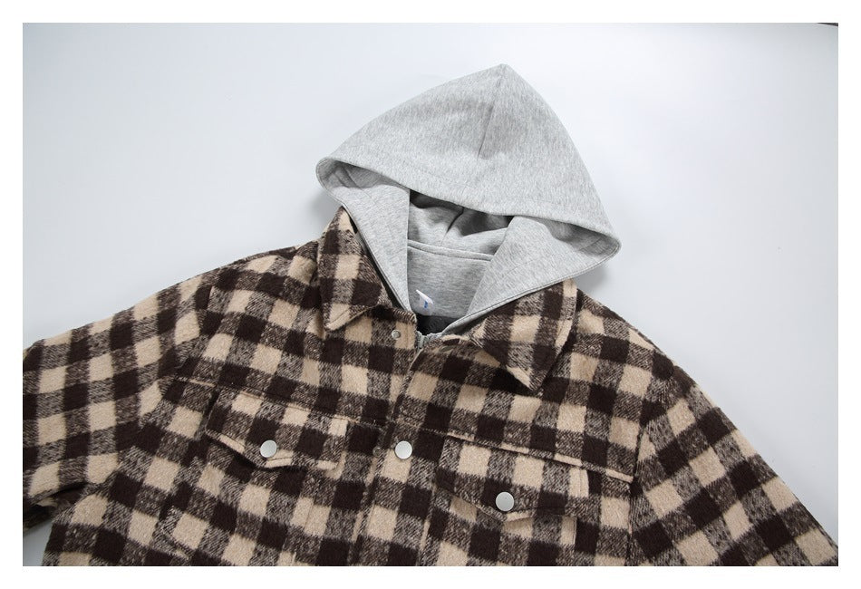 Close-up of a brown and beige checked jacket with a gray hood, snap-front pockets and a zipper.