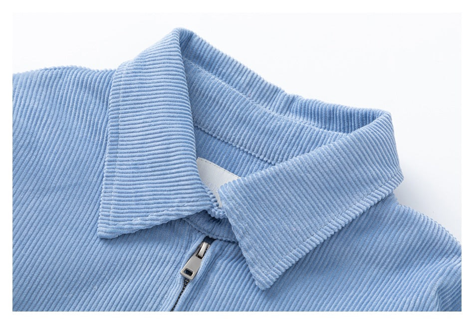Close-up of the light blue corduroy jacket’s pointed collar and metal zipper pull.