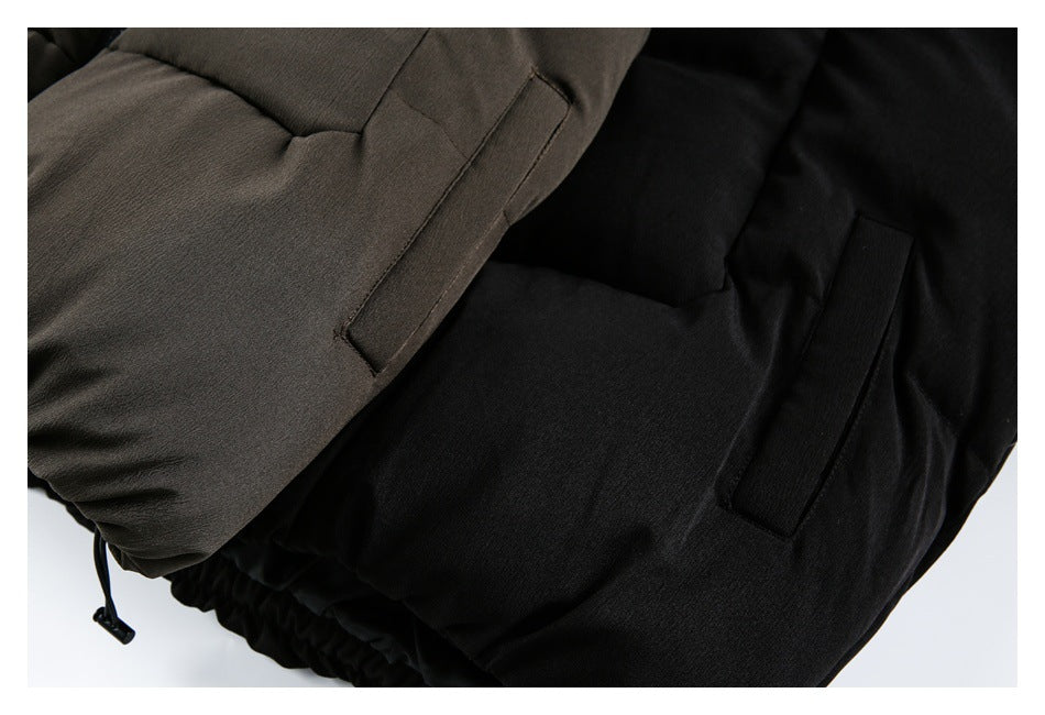 Close-up of brown and black padded jackets showing narrow welt pockets and an adjustable hem cord.
