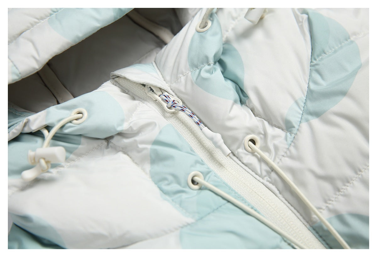 Close-up of the jacket front zipper, drawcord eyelets and cord details on its white and pale aqua print.