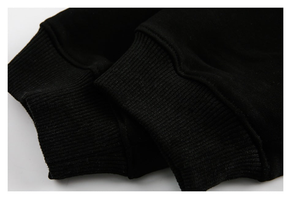 Close-up of black ribbed cuffs and seams on a black garment.