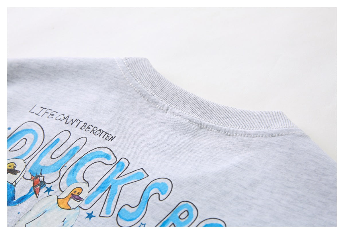 Close-up of a light gray T-shirt neckline and part of a colorful printed graphic.