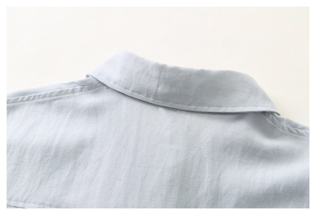 Close-up of the collar and upper back of a pale blue-gray shirt.