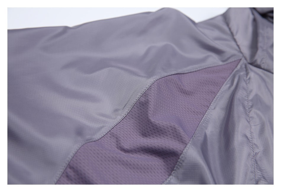 Close-up of a darker mesh ventilation panel set into the gray-lavender jacket.