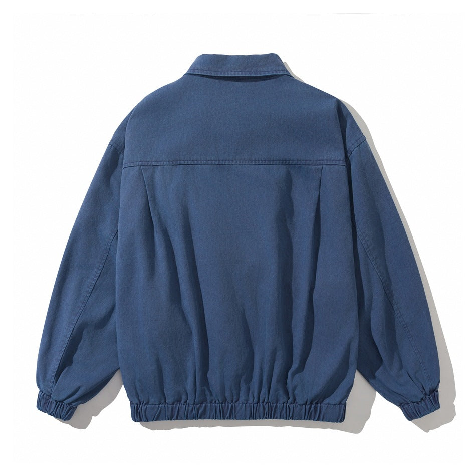 Back view of a blue jacket with a yoke seam, long sleeves, and gathered elastic cuffs and hem.