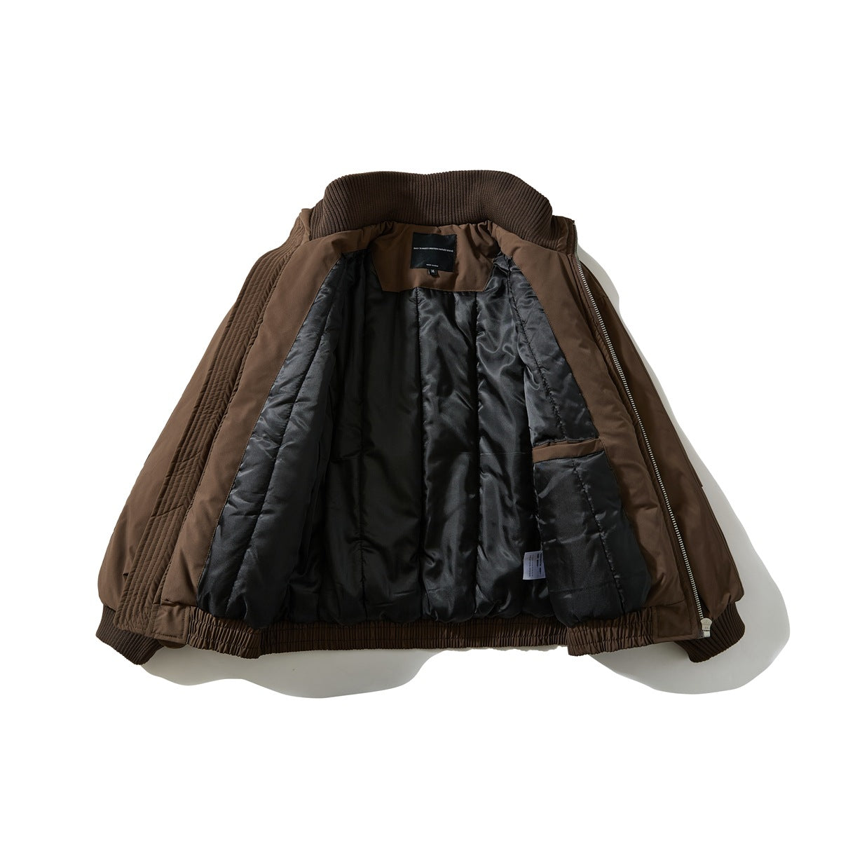 Brown zip-front jacket opened flat, showing its black lining, inner pocket, and dark ribbed collar and cuffs.