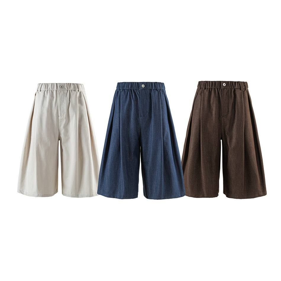 Front views of wide-leg shorts in cream, navy, and brown, each with a gathered waistband.