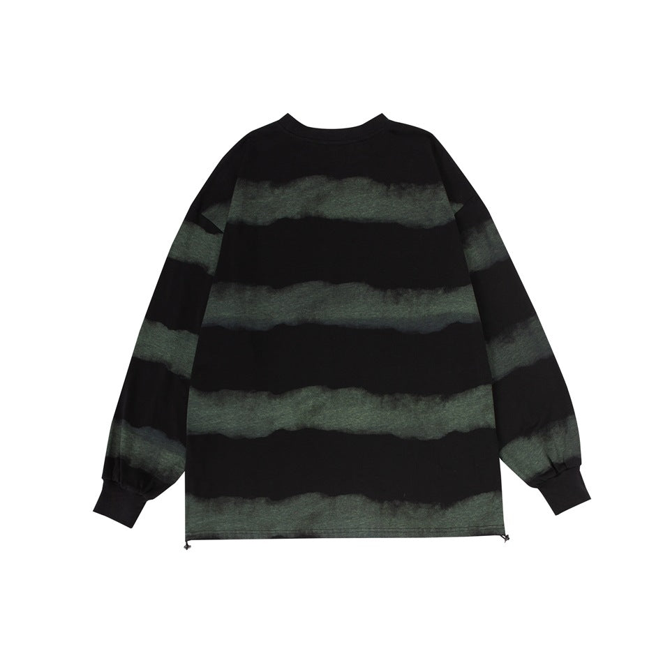 Back view of black long-sleeve crew-neck top with faded green horizontal stripes and ribbed cuffs, flat lay