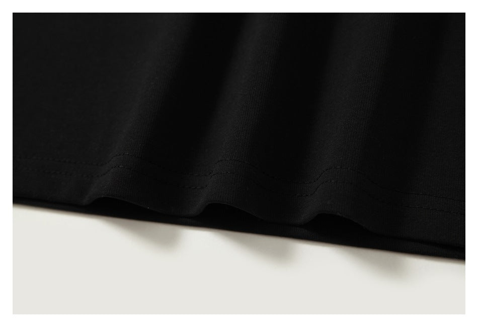 Close-up of the black shirt's lower hem and parallel stitching.