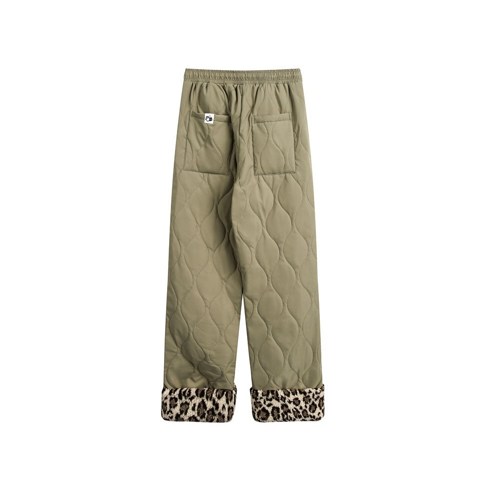 Back view of olive quilted pants with two patch pockets and leopard-print turned-up cuffs.