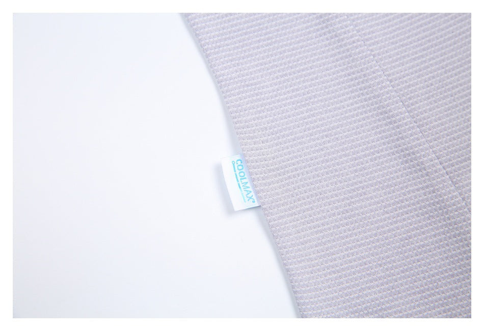 Close-up of a small COOLMAX tag attached to the textured gray-lilac shirt fabric.
