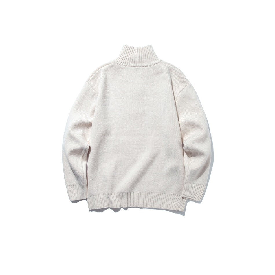 Back view of an ivory quarter-zip knit sweater with a ribbed high collar, cuffs, and hem.