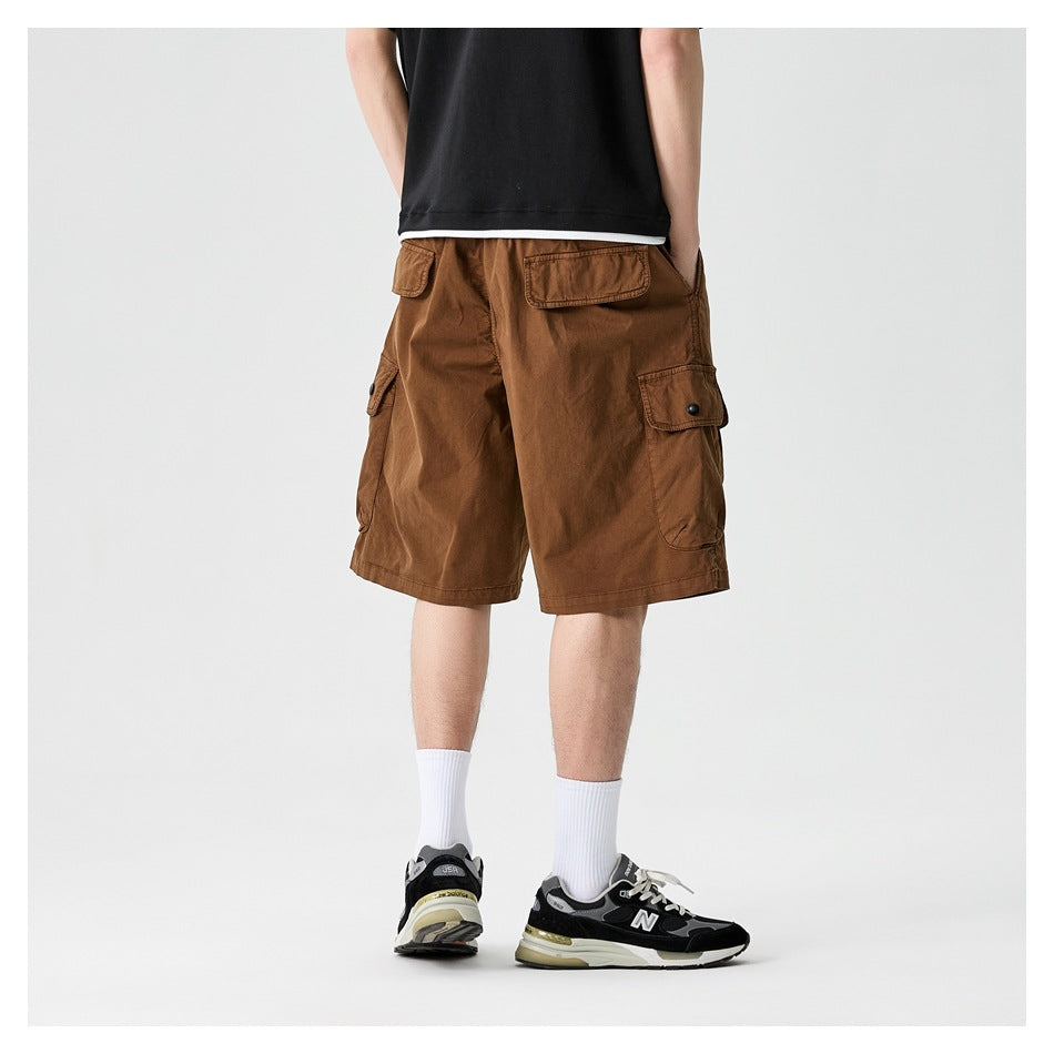 Back view of model wearing light brown cargo shorts showing back flap pocket and side cargo pocket
