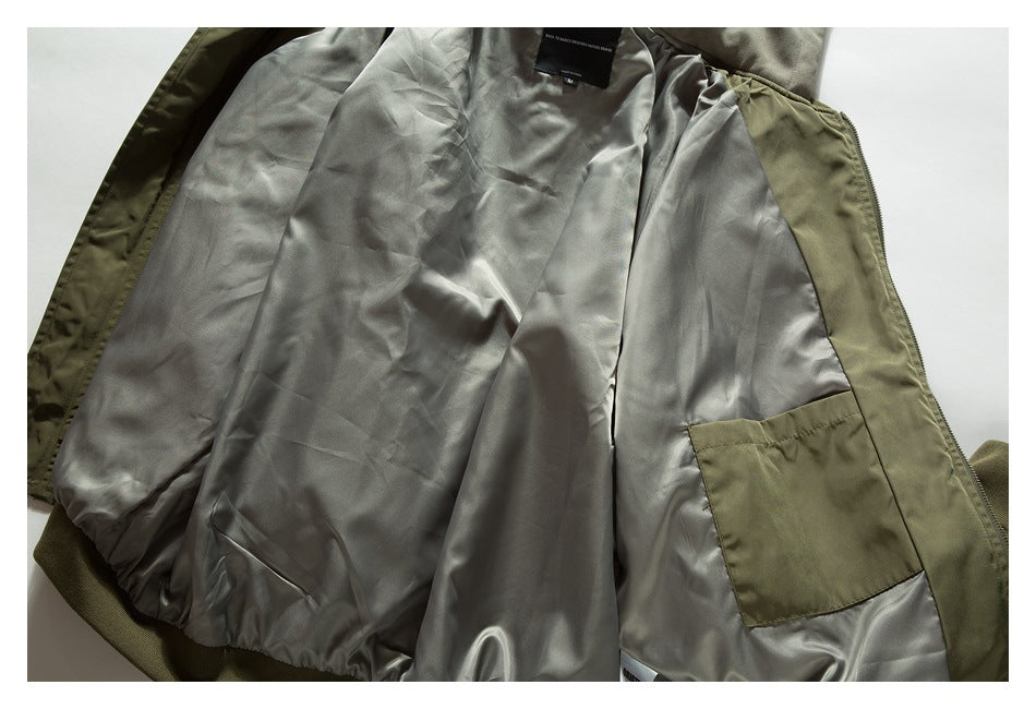 Open olive jacket showing its smooth gray lining, inner pocket, and black neck label.