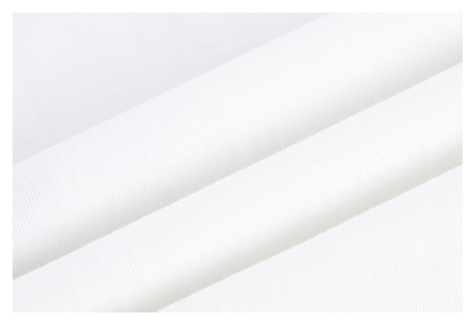 Close-up of white fabric with fine knit texture and soft folds.