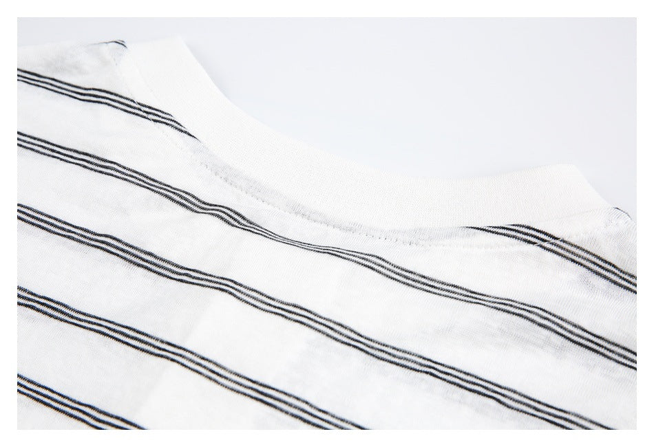 Close-up of the white neckline with narrow black stripes across the knit fabric.