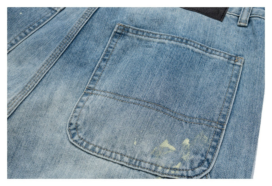 Close-up of a back pocket on light blue jeans, showing double stitching and pale distressed marks.