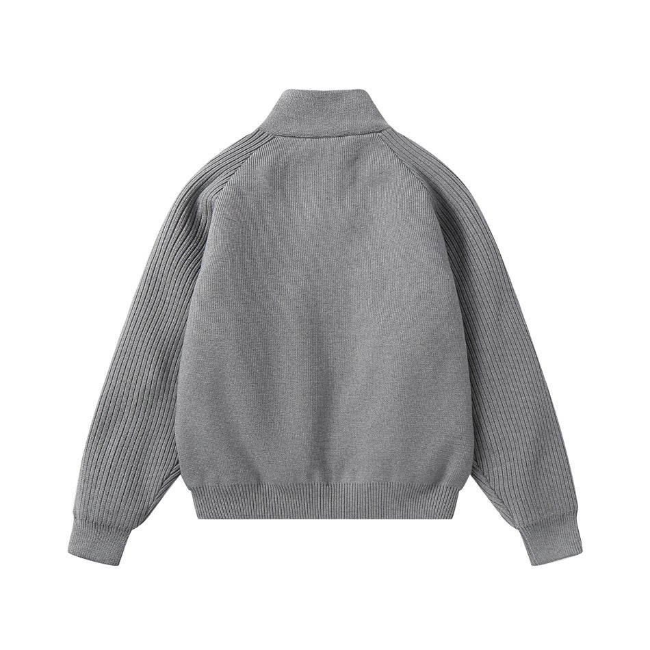 Back of a gray knit jacket with a stand collar, ribbed raglan sleeves, and ribbed hem and cuffs.