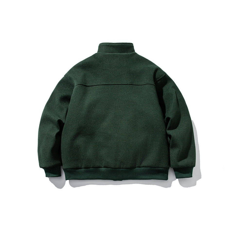 Back view of green stand-collar jacket showing horizontal yoke seam and ribbed cuffs and hem, flat lay