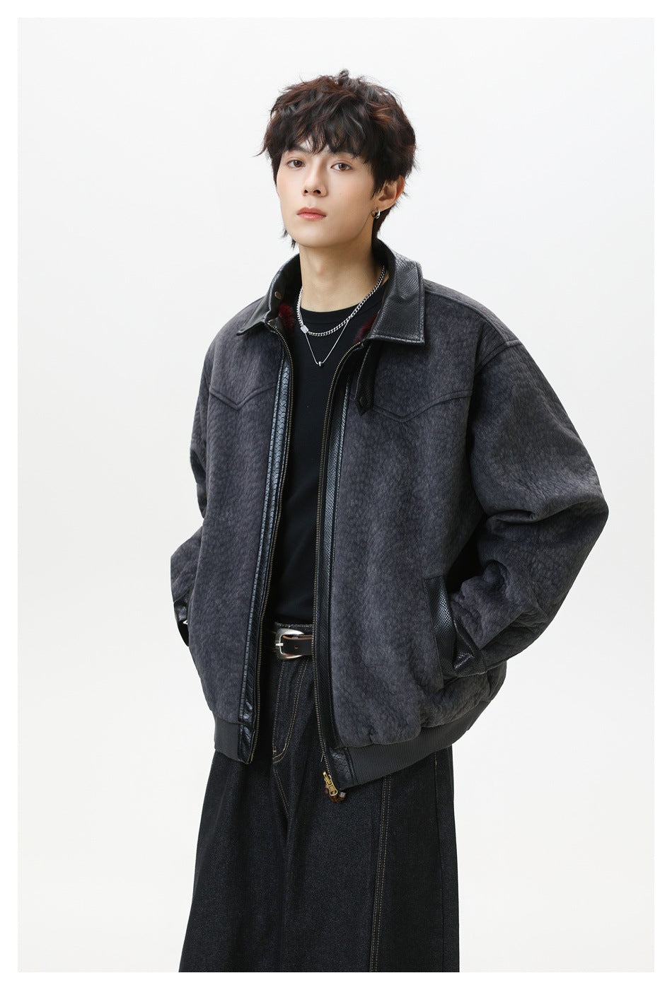 Model wearing a dark charcoal textured jacket with a black collar, zip front, and ribbed hem.