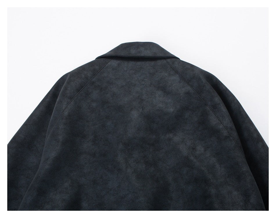 Close-up of the charcoal jacket's back, showing its wide collar and mottled surface.