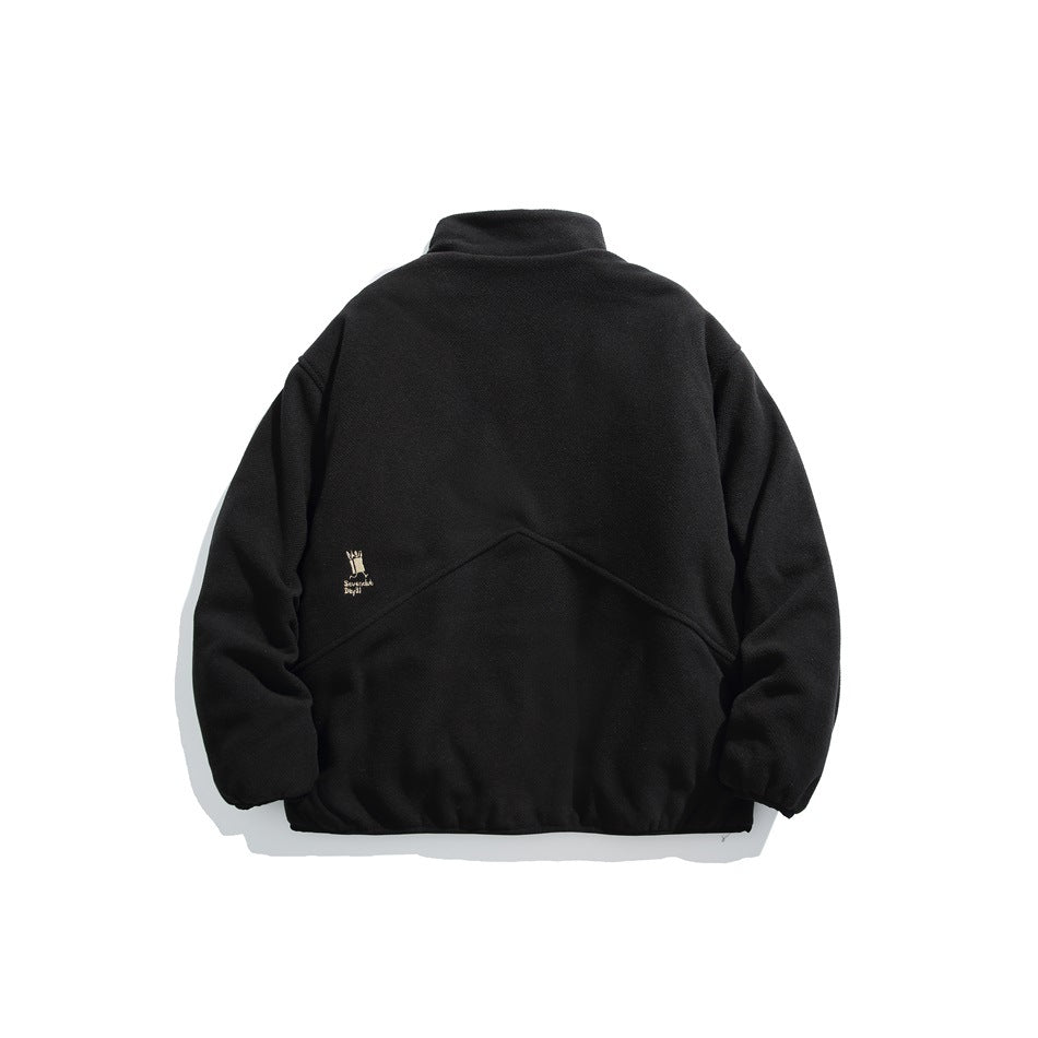 Back view of a black pullover with a raised collar, curved seam detail, and small embroidered mark.