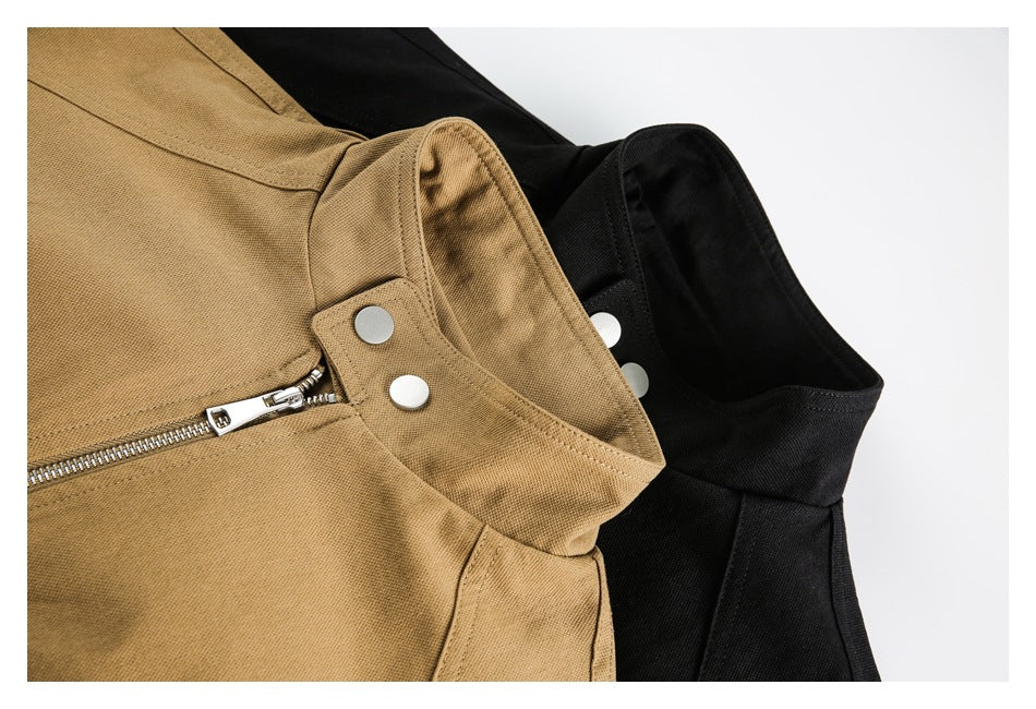 Close-up of tan and black jacket collars with silver snaps and front zipper details.