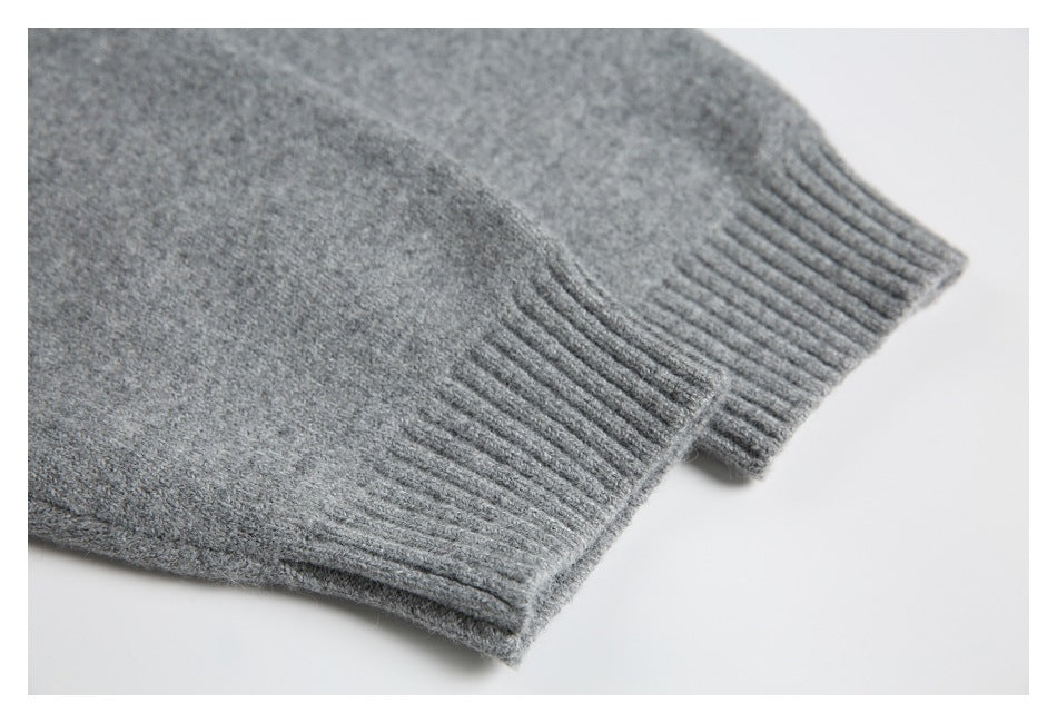 Close-up of a gray knit garment showing a ribbed cuff and fuzzy knit texture.