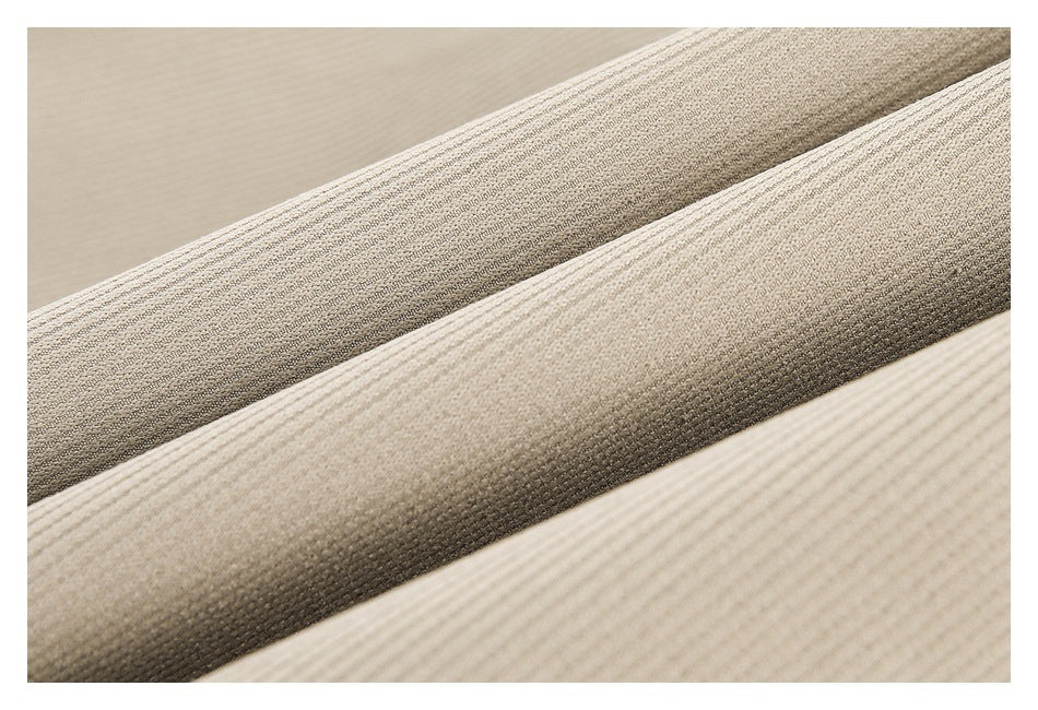 Extreme close-up of parallel folds showing the ribbed texture of taupe fabric.