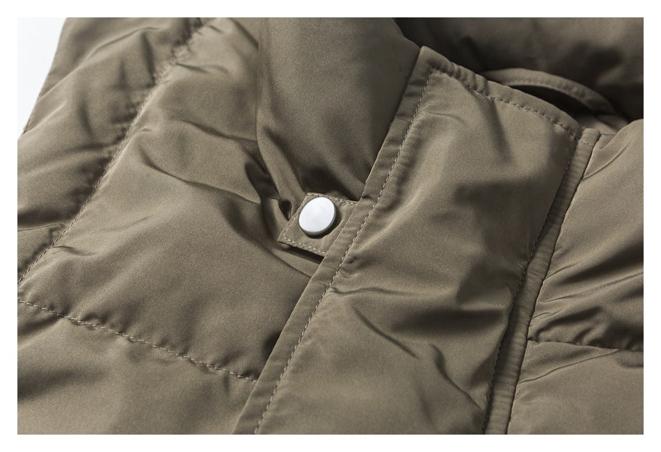 Close-up showing a pale snap fastener and stitched placket on the olive-khaki vest.
