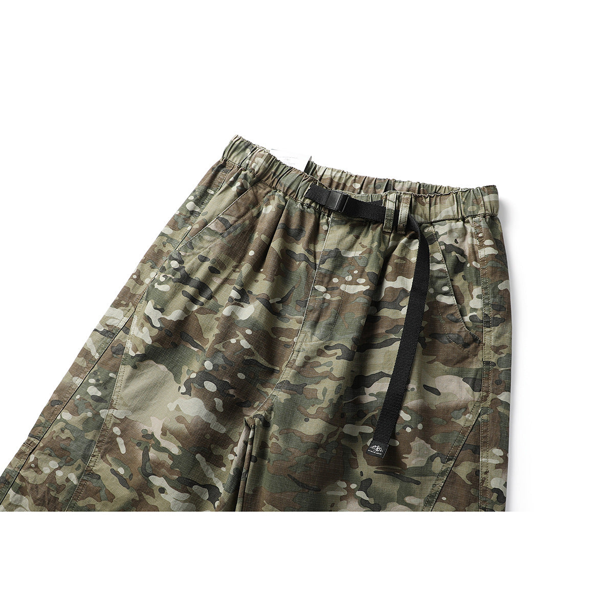 Close view of olive and brown camouflage trousers with an elastic waist, black webbing belt, and front pockets.