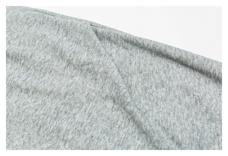 Close-up of heather gray pants fabric with a diagonal seam.
