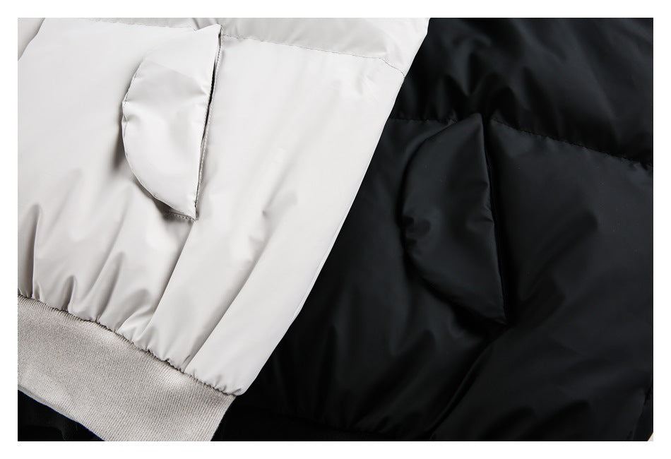 Close-up of flap pockets and ribbed hems on light gray and black puffer jackets.