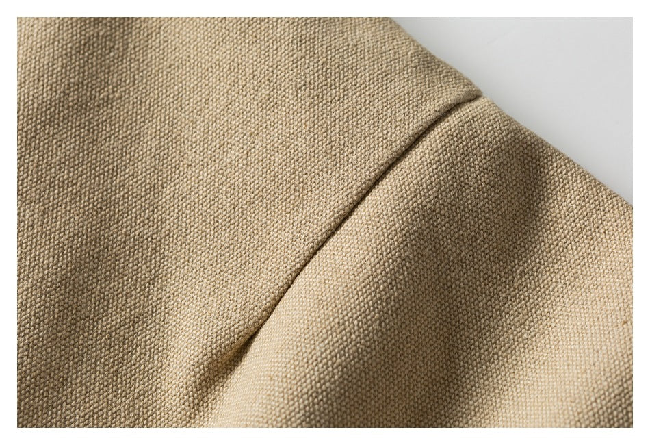 Close-up of the beige jacket fabric and a curved seam.