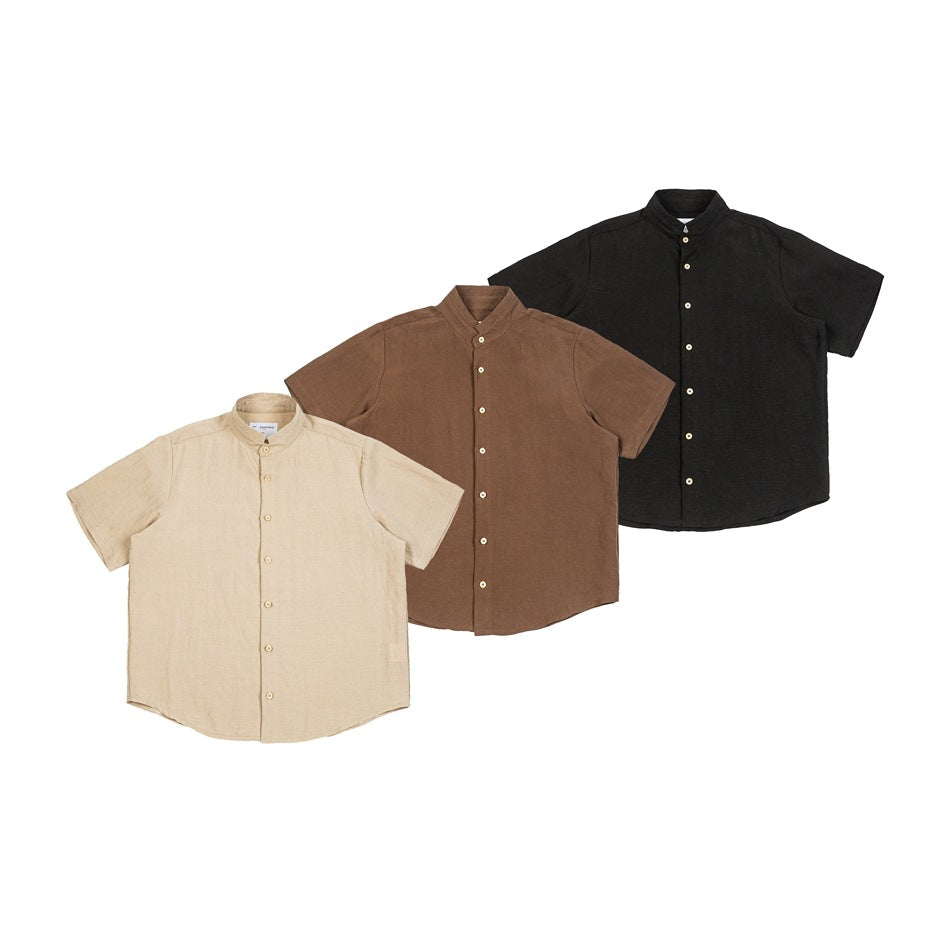 Front view of three short-sleeve button-up shirts with band collars in beige, brown, and black.
