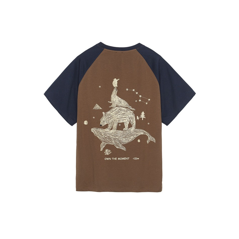Back of brown raglan T-shirt with navy sleeves and a large cream graphic of stacked animals on a whale