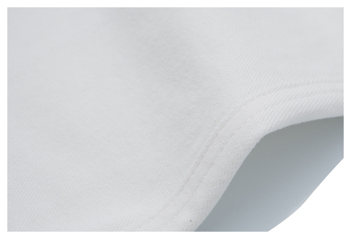 Close-up of a stitched seam on white jeans.