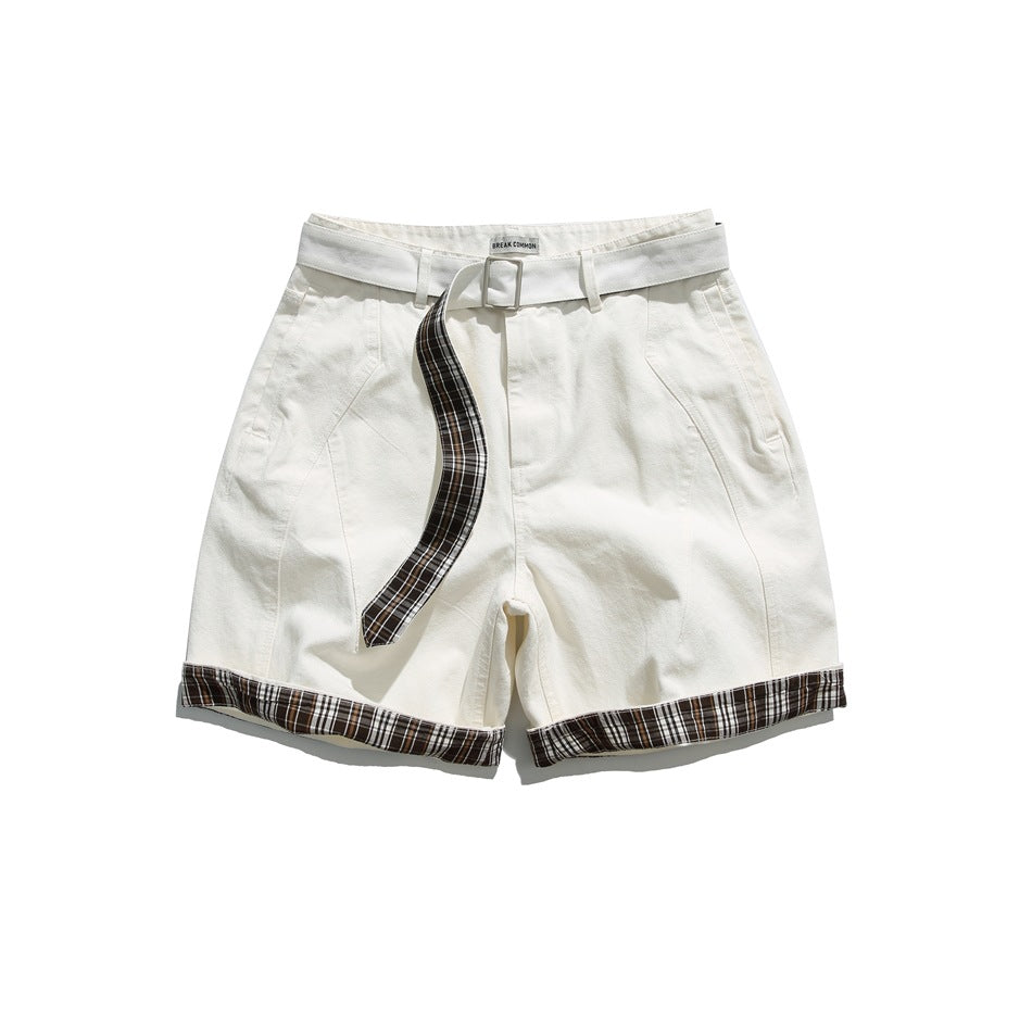 Off-white shorts with a buckled belt, plaid-backed belt tail and plaid cuffed hems, front flat lay