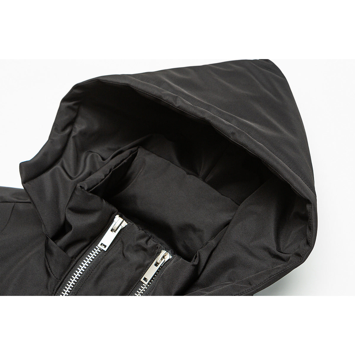 Close-up of a black jacket's hood interior and two silver front zipper pulls.