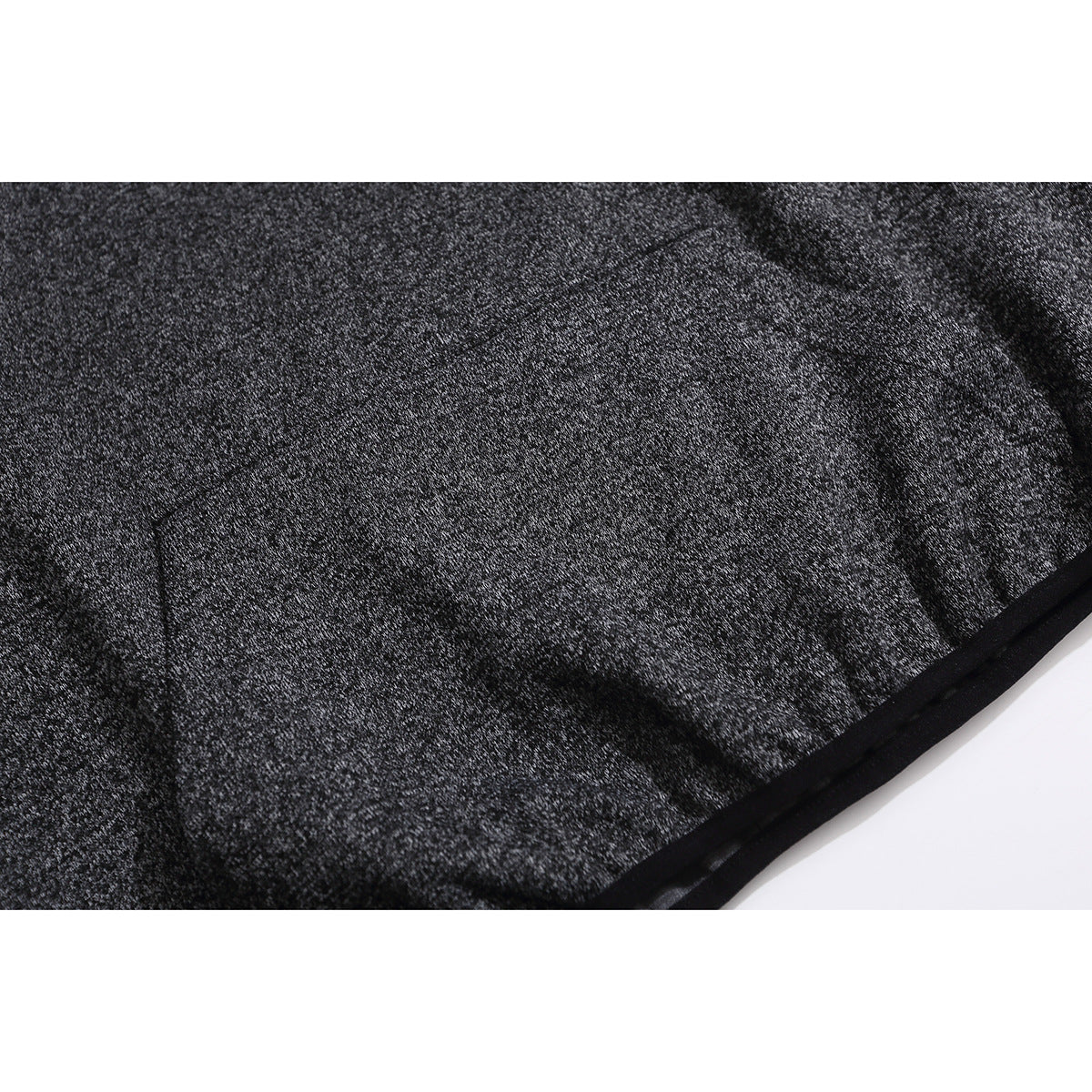 Close-up of charcoal marled hoodie fabric and the black-trimmed lower hem.