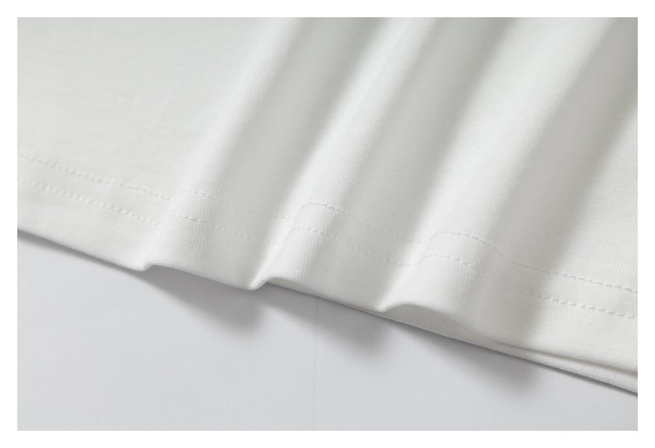 Close-up of the white shirt's hem, showing parallel rows of stitching.