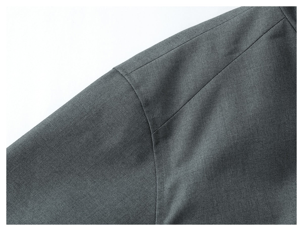 Close-up of dark gray garment fabric and angled shoulder seams.