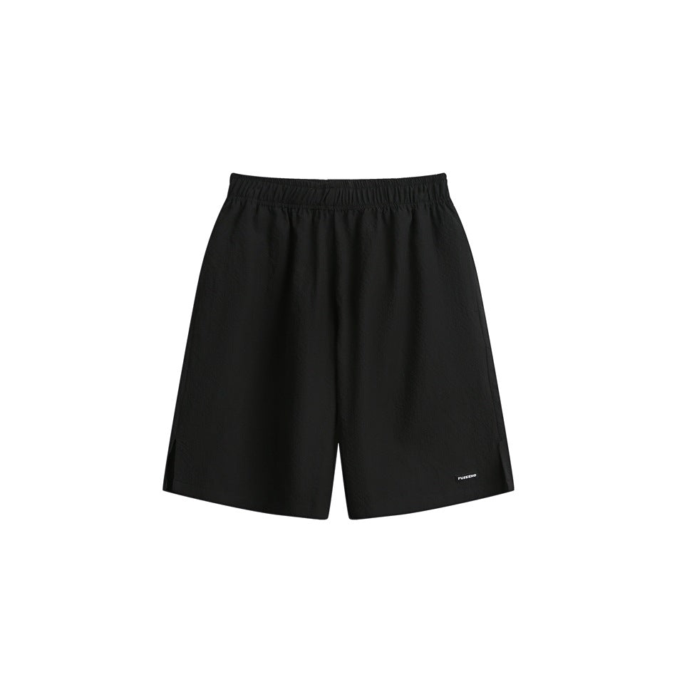 Black knee-length shorts with elastic waistband, side hem slits and small label, flat front view