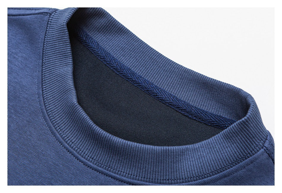 Close-up of a blue sweatshirt's ribbed crew neckline and inner seam.
