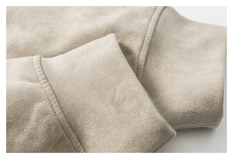 Close-up of the taupe sweatshirt’s folded sleeve cuff and fabric texture.