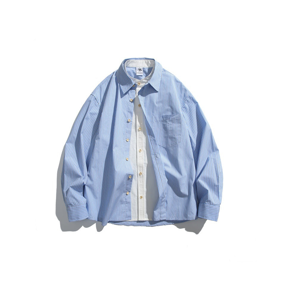 Light blue striped long-sleeve button shirt flat lay with white layered under-shirt at the front and a chest pocket
