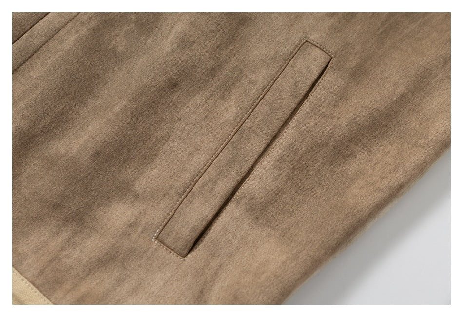 Close-up of a brown garment panel with a narrow welt pocket.