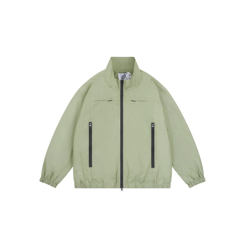 Light green stand-collar zip jacket with dark front zipper, zippered pockets and elastic cuffs and hem, flat front view