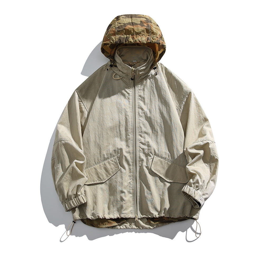 Khaki hooded zip jacket with camouflage hood lining, flap pockets and drawcord hem, flat lay